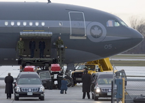 Military pallbearers carry the caskets of Cpl. Nicolas Beauchamps and Pte. Michel Levesque Jr., who were killed in Afghanistan on Saturday, to waiting hearses during a  repatriation ceremony at Canadian Forces base Trenton, Tuesday November 20, 2007.  THE CANADIAN PRESS/Fred Chartrand